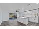 Bright kitchen featuring an island, white cabinets, and sliding doors to a screened lanai at 13821 Judy Ave, Hudson, FL 34667