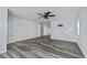 Spacious living room boasts gray floors, white trim, and a ceiling fan at 13821 Judy Ave, Hudson, FL 34667