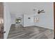 Bright living room boasting updated floors, modern ceiling fan, and access to rear patio at 13821 Judy Ave, Hudson, FL 34667