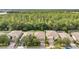 Aerial view of a neighborhood with lush greenery and well-maintained homes at 1410 Halapa Way, Trinity, FL 34655