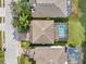 Aerial view of the home with a screened-in pool and manicured backyard at 1410 Halapa Way, Trinity, FL 34655