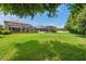Expansive backyard with lush green grass and screened in patio areas, perfect for outdoor entertaining at 1410 Halapa Way, Trinity, FL 34655