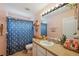 Updated bathroom with decorative shower curtain, modern vanity, and neutral-toned walls at 1410 Halapa Way, Trinity, FL 34655