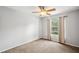 Neutral bedroom with a window and ceiling fan is painted in a light calming shade of gray at 1410 Halapa Way, Trinity, FL 34655