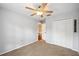 Neutral bedroom with ceiling fan, closet with plenty of storage and carpeted floor at 1410 Halapa Way, Trinity, FL 34655