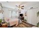 Cozy bedroom featuring a ceiling fan, wood laminate flooring, and decor at 1410 Halapa Way, Trinity, FL 34655