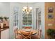 Charming breakfast nook with natural light and wooden table, perfect for enjoying morning meals at 1410 Halapa Way, Trinity, FL 34655