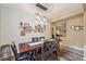 Inviting dining room featuring modern light fixtures and a rustic wood table with seating for six at 1410 Halapa Way, Trinity, FL 34655
