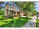 Two-story home featuring well-maintained lawn, colorful landscaping and two-car garage at 1410 Halapa Way, Trinity, FL 34655
