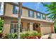 Inviting two-story home with a brick driveway, two-car garage, and well-maintained landscaping at 1410 Halapa Way, Trinity, FL 34655