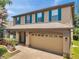 Spacious home with a two-car garage, a well-manicured lawn, and colorful shrubbery at 1410 Halapa Way, Trinity, FL 34655