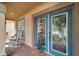 Inviting front porch with rocking chairs and a blue front door, offering a welcoming entrance to the home at 1410 Halapa Way, Trinity, FL 34655