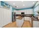 Bright kitchen with white cabinets, stainless steel appliances, and a center island perfect for entertaining at 1410 Halapa Way, Trinity, FL 34655