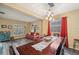 Spacious living and dining area with wood-like floors, stylish decor, and a bright atmosphere at 1410 Halapa Way, Trinity, FL 34655