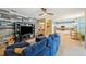 Open concept living area with TV, kitchen and dining spaces, with a blue couch at 1410 Halapa Way, Trinity, FL 34655