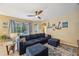 Comfortable living room with large windows, a plush sofa, and nautical décor for a relaxed atmosphere at 1410 Halapa Way, Trinity, FL 34655