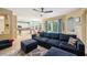 Spacious living room with an open layout to the kitchen and view of the outdoor patio at 1410 Halapa Way, Trinity, FL 34655