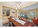 Open-concept living and dining area with wood-like floors, stylish décor and ample natural light at 1410 Halapa Way, Trinity, FL 34655