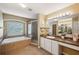 Relaxing main bathroom featuring a soaking tub, separate shower, and well-lit vanity at 1410 Halapa Way, Trinity, FL 34655