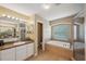Well-lit main bathroom with a tub, shower, and spacious vanity area at 1410 Halapa Way, Trinity, FL 34655