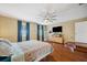 Lovely main bedroom featuring hardwood floors, recessed ceiling, and ample space at 1410 Halapa Way, Trinity, FL 34655