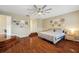 Large main bedroom with hardwood floors and decorative elements on the wall at 1410 Halapa Way, Trinity, FL 34655