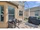 Outdoor patio featuring two chairs and a grill for entertaining guests at 1410 Halapa Way, Trinity, FL 34655