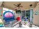 Enclosed patio boasting cozy seating arrangements and a view of the pool and backyard at 1410 Halapa Way, Trinity, FL 34655