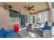 Enclosed patio featuring comfortable seating, a ceiling fan, and a view of the pool and backyard at 1410 Halapa Way, Trinity, FL 34655