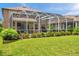 Relaxing screened-in pool with patio, privacy landscaping, and beautiful lawn at 1410 Halapa Way, Trinity, FL 34655