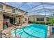 Enclosed backyard pool with outdoor patio furniture, perfect for relaxing or entertaining guests at 1410 Halapa Way, Trinity, FL 34655
