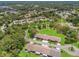 Overhead view showcasing homes nestled among lush trees in a tranquil residential neighborhood at 1415 Pinewood Hills Ct, Spring Hill, FL 34606