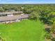 Vast green backyard features outdoor seating, perfect for entertaining or peaceful enjoyment of nature at 1415 Pinewood Hills Ct, Spring Hill, FL 34606
