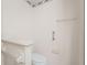 A half bathroom with a white toilet, grab bars for assistance, and a practical design at 1415 Pinewood Hills Ct, Spring Hill, FL 34606