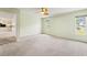 This light and airy bedroom is spacious, features a ceiling fan, and has lovely views out the windows at 1415 Pinewood Hills Ct, Spring Hill, FL 34606