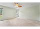 This is a spacious bedroom with a ceiling fan and an abundance of natural light coming in from two windows at 1415 Pinewood Hills Ct, Spring Hill, FL 34606