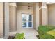 Covered front entryway with tiled brick support beams and double front doors at 1415 Pinewood Hills Ct, Spring Hill, FL 34606