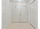 Interior entryway featuring neutral flooring and a large double door with decorative windows at 1415 Pinewood Hills Ct, Spring Hill, FL 34606