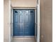 Exterior view of the blue double front doors with decorative windows at 1415 Pinewood Hills Ct, Spring Hill, FL 34606