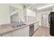 Functional kitchen with stainless sink, dishwasher, and plenty of cabinet storage at 1415 Pinewood Hills Ct, Spring Hill, FL 34606
