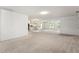 Open-concept living space with neutral carpeting throughout at 1415 Pinewood Hills Ct, Spring Hill, FL 34606