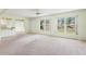 Bright and airy living room features large windows and a ceiling fan at 1415 Pinewood Hills Ct, Spring Hill, FL 34606