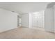 Spacious living room featuring neutral carpet and a double front door at 1415 Pinewood Hills Ct, Spring Hill, FL 34606