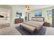 Bright main bedroom with neutral colors, king bed, and decorative art pieces create a relaxing space at 1415 Pinewood Hills Ct, Spring Hill, FL 34606