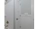 Bathroom features tile shower with brushed nickel fixtures and white cabinets at 1830 Santa Barbara Dr, Dunedin, FL 34698