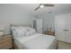 Inviting bedroom with a cozy bed, ceiling fan, and ample natural light at 1830 Santa Barbara Dr, Dunedin, FL 34698