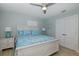 Comfortable bedroom featuring a large bed with decorative pillows and matching lamps at 1830 Santa Barbara Dr, Dunedin, FL 34698