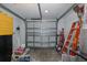 Spacious garage featuring a new garage door, storage space and concrete floors at 1830 Santa Barbara Dr, Dunedin, FL 34698