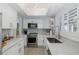 Modern kitchen with stainless steel appliances, light countertops and white cabinets at 1830 Santa Barbara Dr, Dunedin, FL 34698