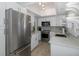 Bright kitchen with stainless steel appliances, countertops, and sleek cabinets at 1830 Santa Barbara Dr, Dunedin, FL 34698